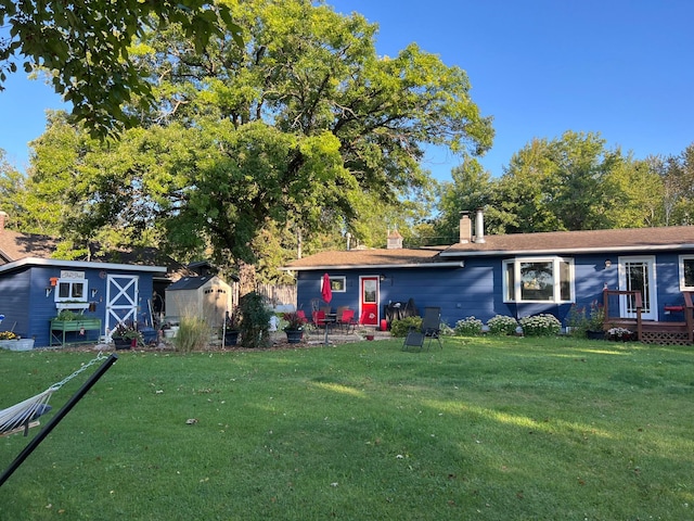 1778 Wabanica Bay Dr NW, Baudette, MN 56623 - view of front of house with a front lawn, a chimney, an outbuilding, and a storage shed