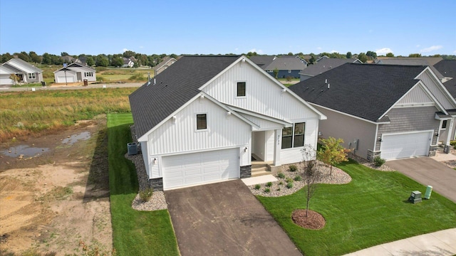 2133 Westpointe Dr, Hastings, MN 55033 - modern farmhouse with concrete driveway, a shingled roof, a front yard, a residential view, and board and batten siding