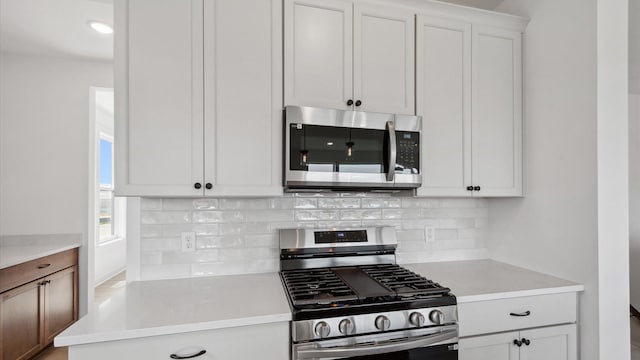 2133 Westpointe Dr, Hastings, MN 55033 - kitchen featuring stainless steel appliances, decorative backsplash, light countertops, and white cabinets