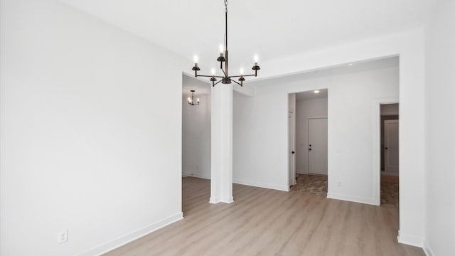 2133 Westpointe Dr, Hastings, MN 55033 - unfurnished dining area with a chandelier, wood finished floors, and baseboards