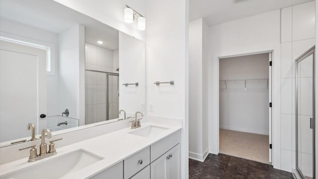 2133 Westpointe Dr, Hastings, MN 55033 - bathroom with a shower stall, a spacious closet, double vanity, and baseboards