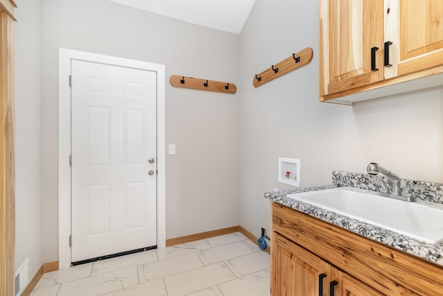 575 Elins Lake Rd SE, Cambridge, MN 55008 - washroom with hookup for a washing machine, cabinet space, light marble finish floors, and baseboards