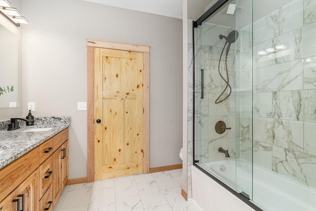 575 Elins Lake Rd SE, Cambridge, MN 55008 - full bath with baseboards, marble look tile flooring, enclosed tub / shower combo, vanity, and toilet