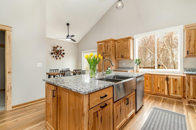 575 Elins Lake Rd SE, Cambridge, MN 55008 - kitchen with a sink, stainless steel dishwasher, light wood-type flooring, a kitchen island with sink, and high vaulted ceiling