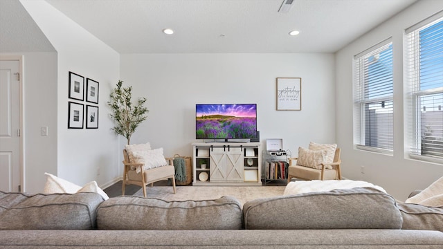 living room featuring baseboards and recessed lighting