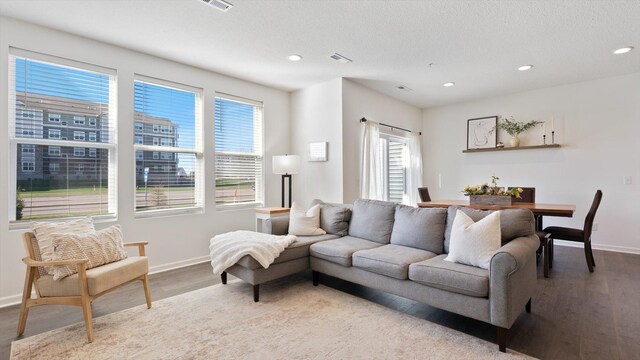 living room with baseboards, recessed lighting, and wood finished floors