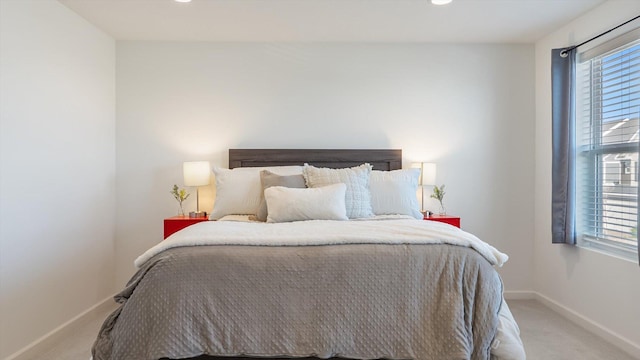 bedroom featuring baseboards, multiple windows, recessed lighting, and light colored carpet