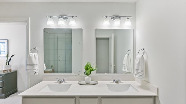 bathroom featuring double vanity, a sink, and a stall shower