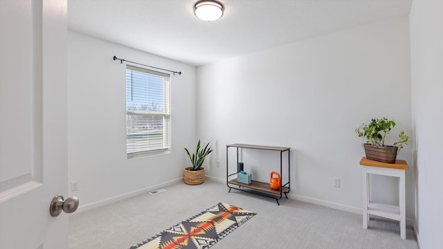 interior space featuring carpet floors, baseboards, and visible vents