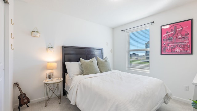 carpeted bedroom featuring baseboards
