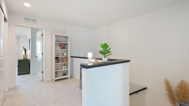 interior space with baseboards, light colored carpet, recessed lighting, and visible vents