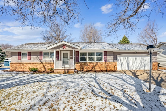 ranch-style house featuring an attached garage, driveway, and brick siding