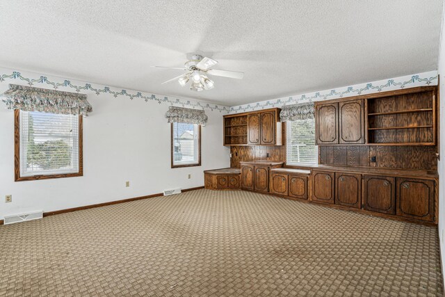 kitchen featuring light carpet, ceiling fan, open shelves, and visible vents