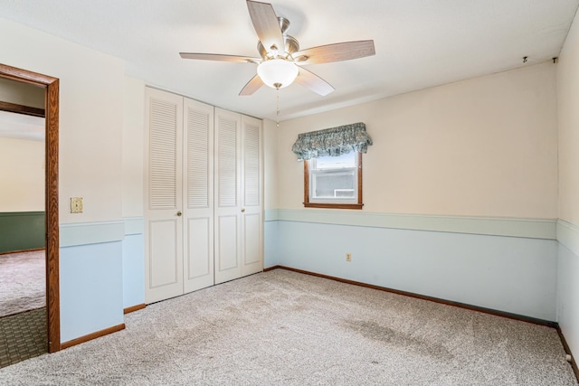 unfurnished bedroom with a closet, a ceiling fan, and carpet flooring