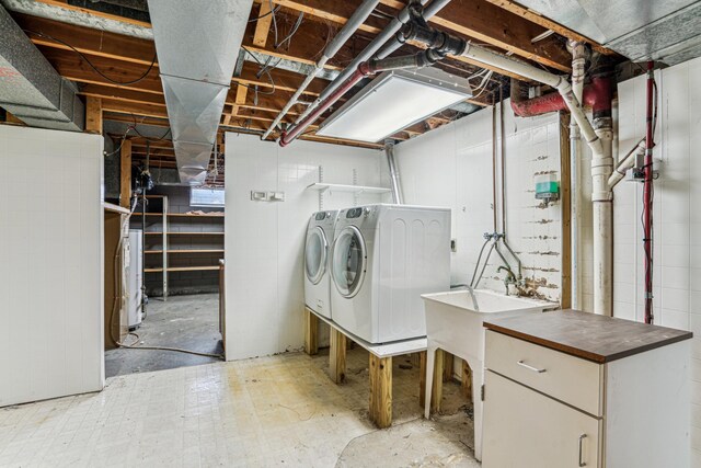 laundry room with independent washer and dryer, laundry area, a sink, and water heater