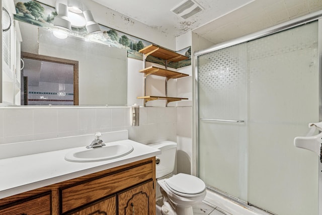 bathroom with visible vents, toilet, vanity, backsplash, and a stall shower