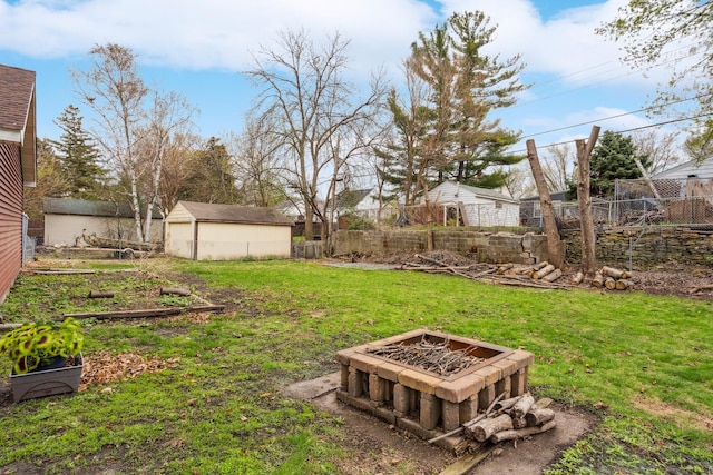 178 Mainzer St, West Saint Paul, MN 55118 - view of yard with fence, a storage unit, an outdoor structure, and an outdoor fire pit