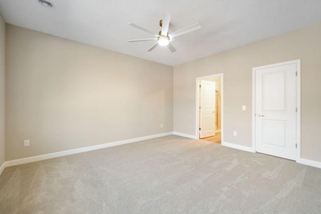 empty room featuring baseboards, carpet flooring, and ceiling fan