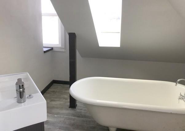 2715 Marshall St NE, Minneapolis, MN 55418 - bathroom with wood finished floors, baseboards, and a freestanding bath