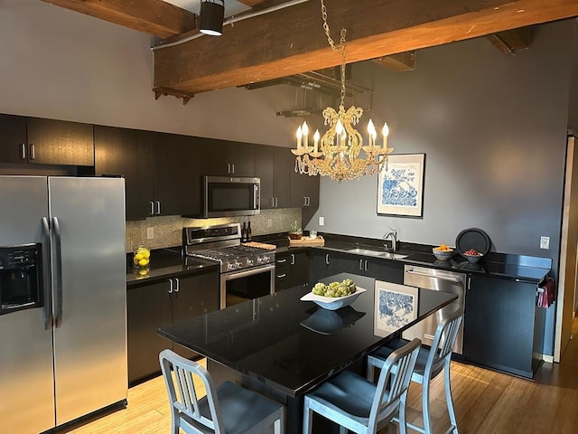 406 Wacouta St Unit 509, Saint Paul, MN 55101 - kitchen with appliances with stainless steel finishes, dark countertops, a sink, beamed ceiling, and backsplash