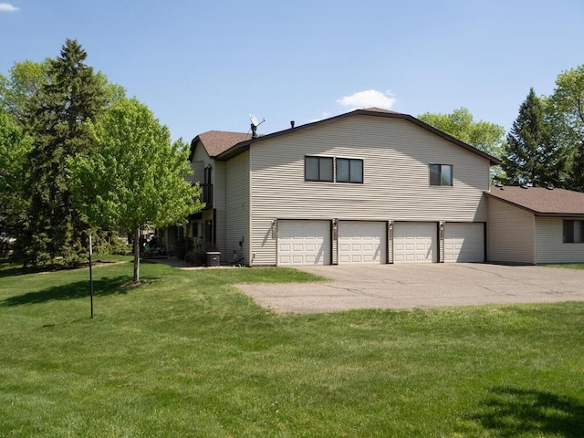 4237 Centerville Rd, Vadnais Heights, MN 55127 - view of property exterior featuring driveway, a garage, a lawn, and central AC unit