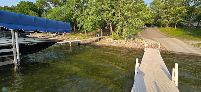 44629 Bear Trl, Lida Twp, MN 56572 - dock with a water view, boat lift, and view of wooded area