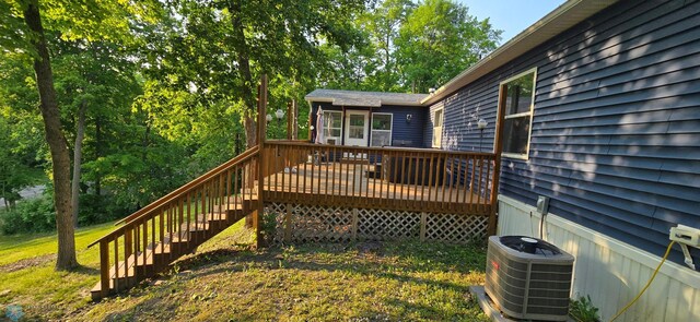 44629 Bear Trl, Lida Twp, MN 56572 - wooden deck with central AC unit, a sunroom, and stairs