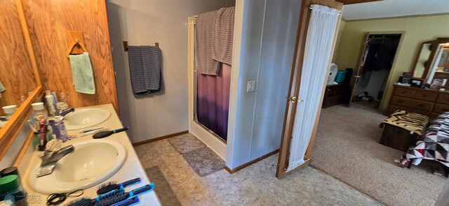 44629 Bear Trl, Lida Twp, MN 56572 - full bathroom featuring a shower stall, double vanity, baseboards, and a walk in closet