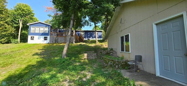 44629 Bear Trl, Lida Twp, MN 56572 - view of grassy yard with stairs and a deck