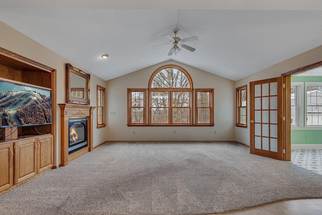 12114 260th St, Saint Cloud, MN 56301 - unfurnished living room with ceiling fan, vaulted ceiling, carpet floors, healthy amount of natural light, and a glass covered fireplace
