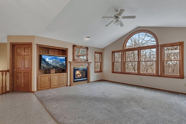 12114 260th St, Saint Cloud, MN 56301 - unfurnished living room with vaulted ceiling, a ceiling fan, a glass covered fireplace, baseboards, and light colored carpet