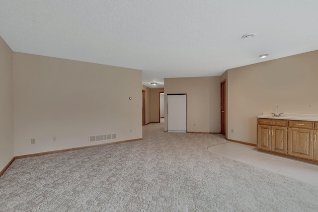 12114 260th St, Saint Cloud, MN 56301 - unfurnished living room featuring light carpet, baseboards, and wet bar