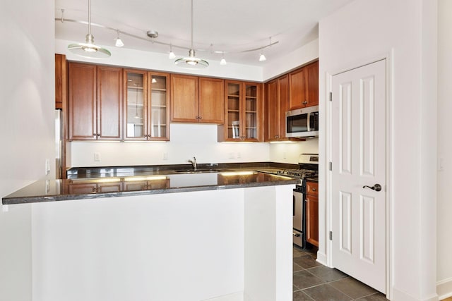500 Grant St Unit 2707, Minneapolis, MN 55404 - kitchen featuring appliances with stainless steel finishes, brown cabinetry, a sink, and a peninsula