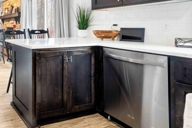 16137 Ahrens Hill Rd, Brainerd, MN 56401 - kitchen featuring stainless steel dishwasher, a peninsula, decorative backsplash, and light wood-style floors