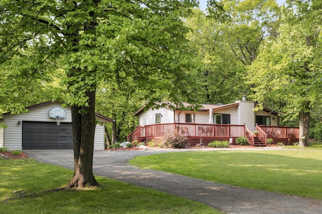 16137 Ahrens Hill Rd, Brainerd, MN 56401 - view of front of house featuring an outdoor structure, a front lawn, a detached garage, and a wooden deck