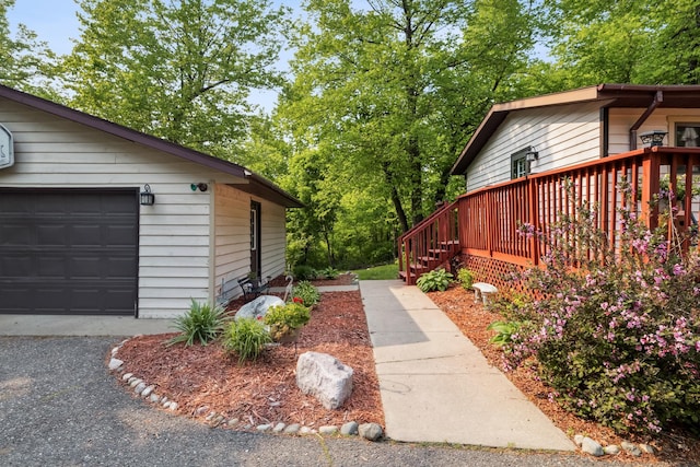 16137 Ahrens Hill Rd, Brainerd, MN 56401 - view of side of home with a garage and a deck