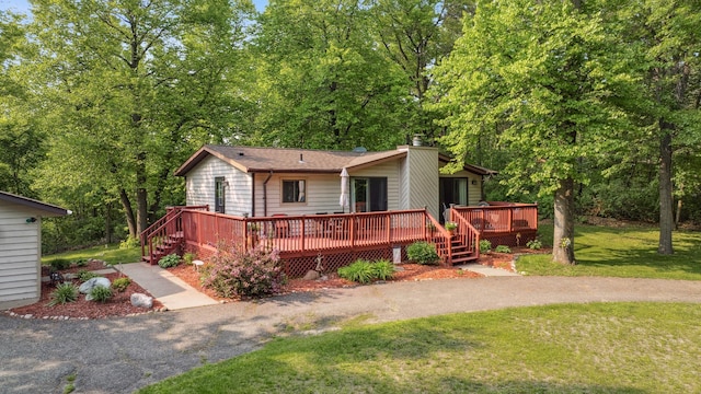 16137 Ahrens Hill Rd, Brainerd, MN 56401 - view of front of home featuring a front yard, a wooden deck, and a chimney