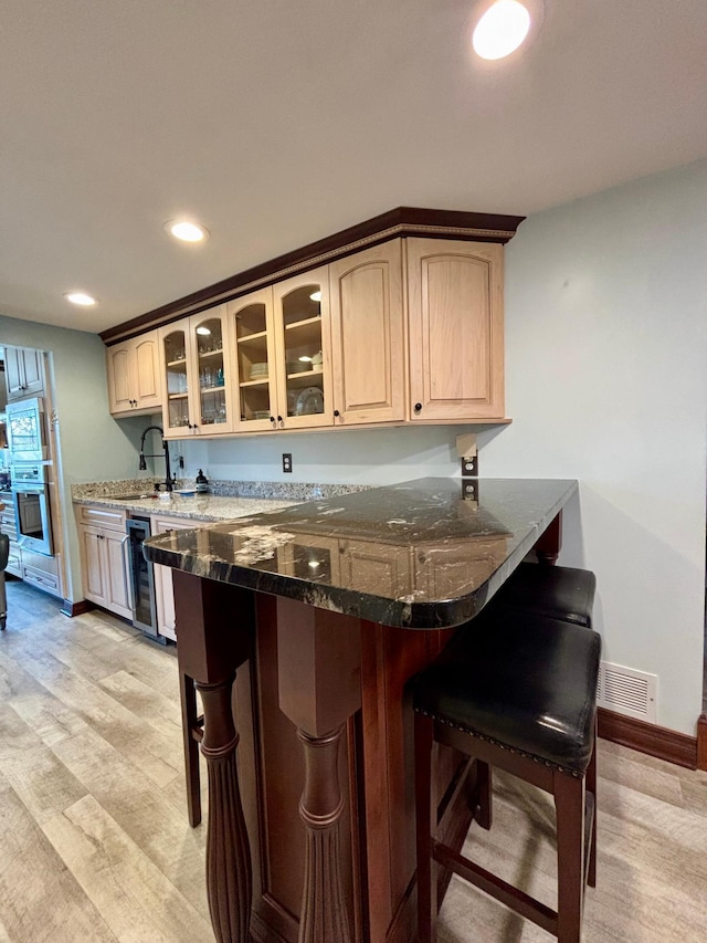 709 Riverside Dr N, North Hudson, WI 54016 - bar with a sink, visible vents, recessed lighting, beverage cooler, and baseboards