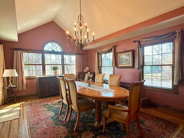 709 Riverside Dr N, North Hudson, WI 54016 - dining area with hardwood / wood-style floors, a chandelier, high vaulted ceiling, and plenty of natural light