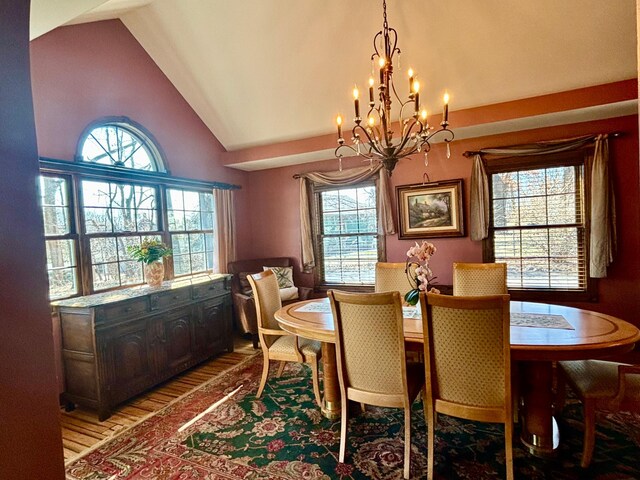 709 Riverside Dr N, North Hudson, WI 54016 - dining space with vaulted ceiling, a chandelier, and plenty of natural light