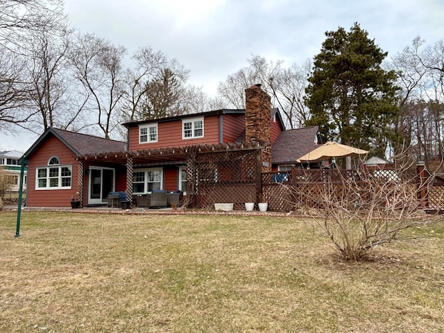 709 Riverside Dr N, North Hudson, WI 54016 - rear view of house with a yard, a patio area, an outdoor hangout area, and a chimney