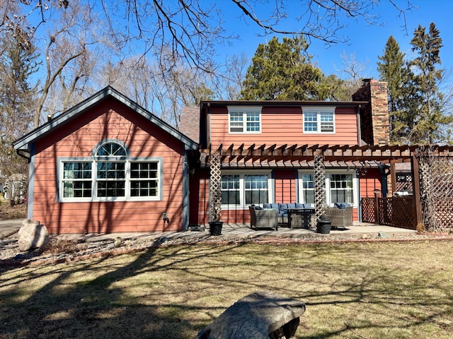 709 Riverside Dr N, North Hudson, WI 54016 - back of property with a chimney, a lawn, an outdoor hangout area, a patio area, and a pergola