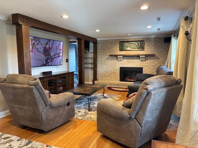 709 Riverside Dr N, North Hudson, WI 54016 - home theater room featuring ornamental molding, recessed lighting, a fireplace, baseboards, and light wood-style floors