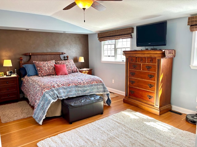 709 Riverside Dr N, North Hudson, WI 54016 - bedroom featuring baseboards, lofted ceiling, a ceiling fan, and wood finished floors