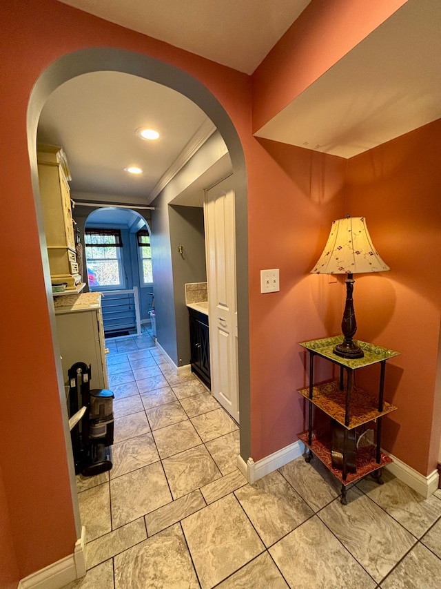 709 Riverside Dr N, North Hudson, WI 54016 - hall with crown molding, arched walkways, baseboards, and recessed lighting