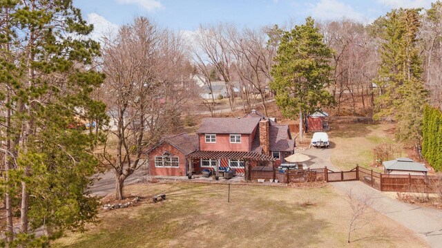 709 Riverside Dr N, North Hudson, WI 54016 - view of front of home with fence, a chimney, a gazebo, a front yard, and a patio area