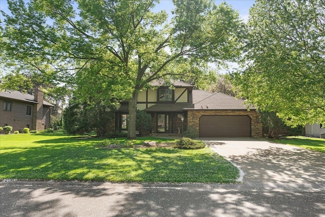 1317 Waterford Rd, Woodbury, MN 55125 - view of front of house with a garage, concrete driveway, a front yard, and stone siding