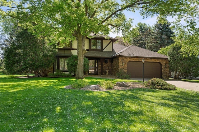 1317 Waterford Rd, Woodbury, MN 55125 - view of front of home featuring an attached garage, a front lawn, driveway, brick siding, and stucco siding