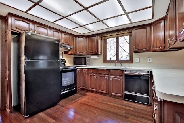 1317 Waterford Rd, Woodbury, MN 55125 - kitchen featuring black appliances, under cabinet range hood, a sink, dark wood-style floors, and light countertops