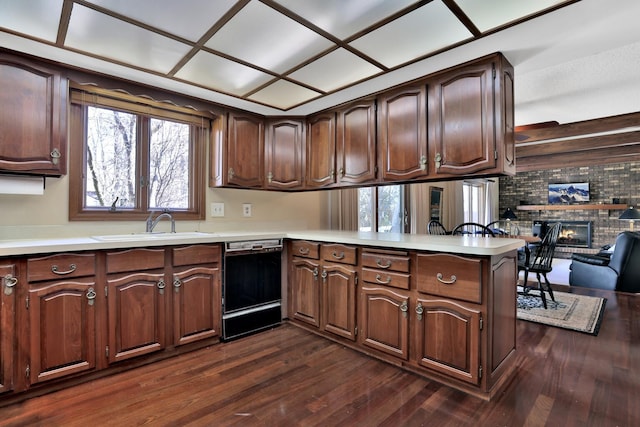1317 Waterford Rd, Woodbury, MN 55125 - kitchen with black dishwasher, dark wood finished floors, a peninsula, and light countertops
